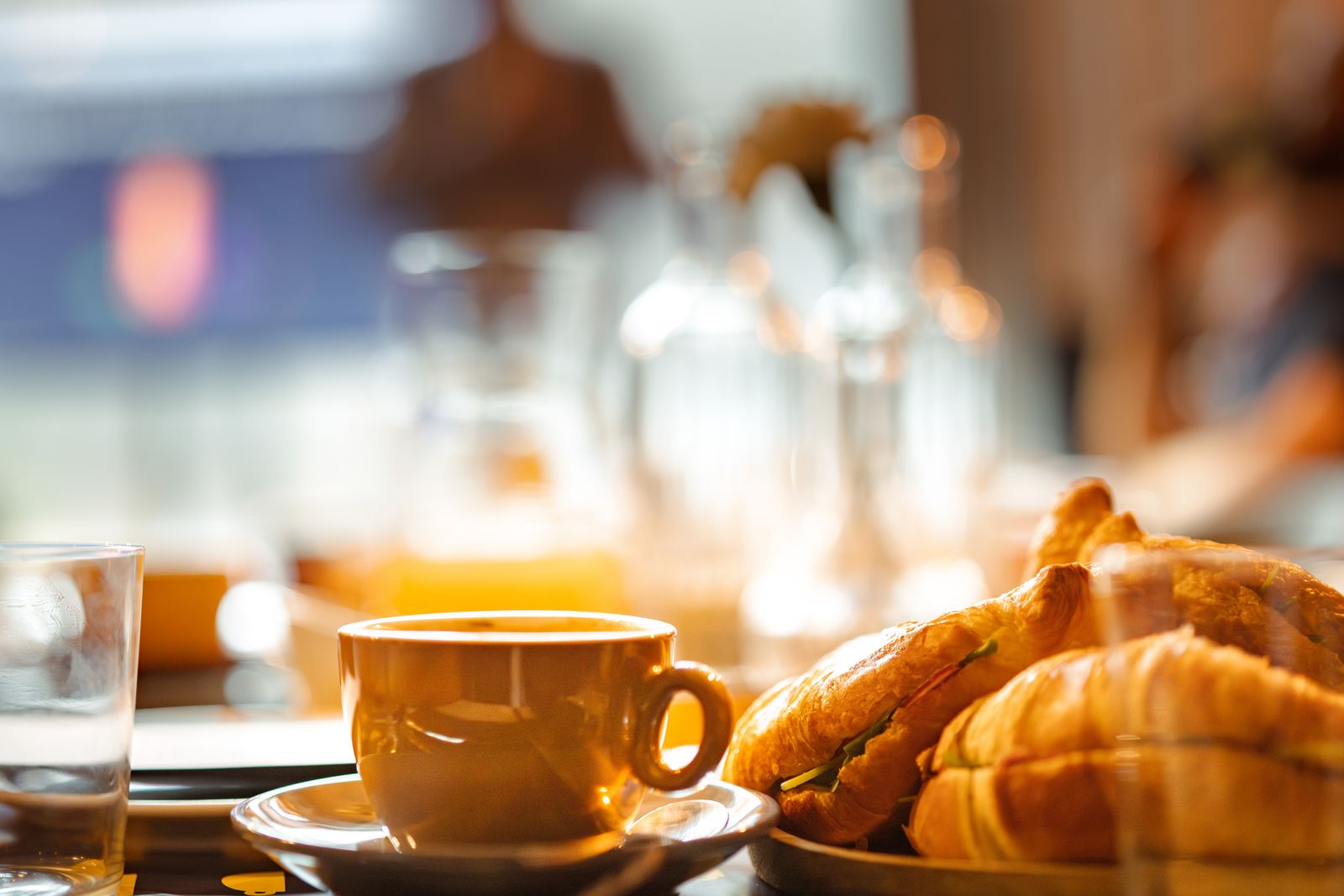 Coffee and croissants on a wooden café table