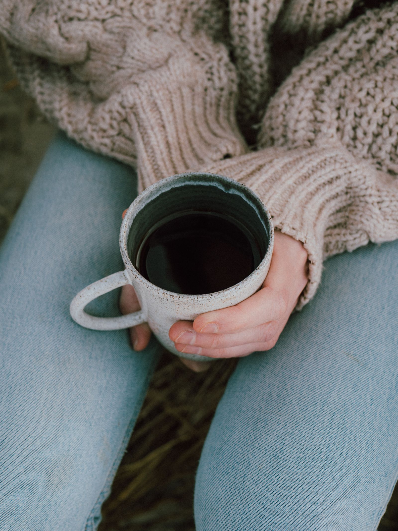 Hands wrapped around a warm mug of coffee