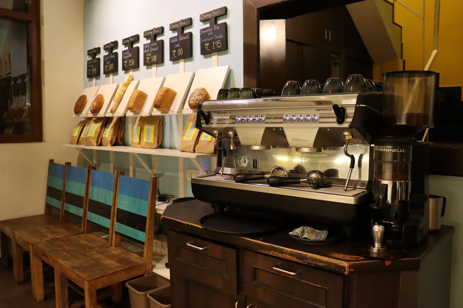 The café counter with the espresso machine and fresh bread